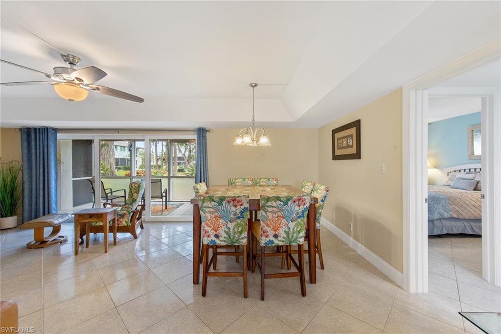 263 Candycane Lane, Unit 5 Naples, FL 34112 - Photo 21 of 49 a view of a dining room with furniture and a chandelier