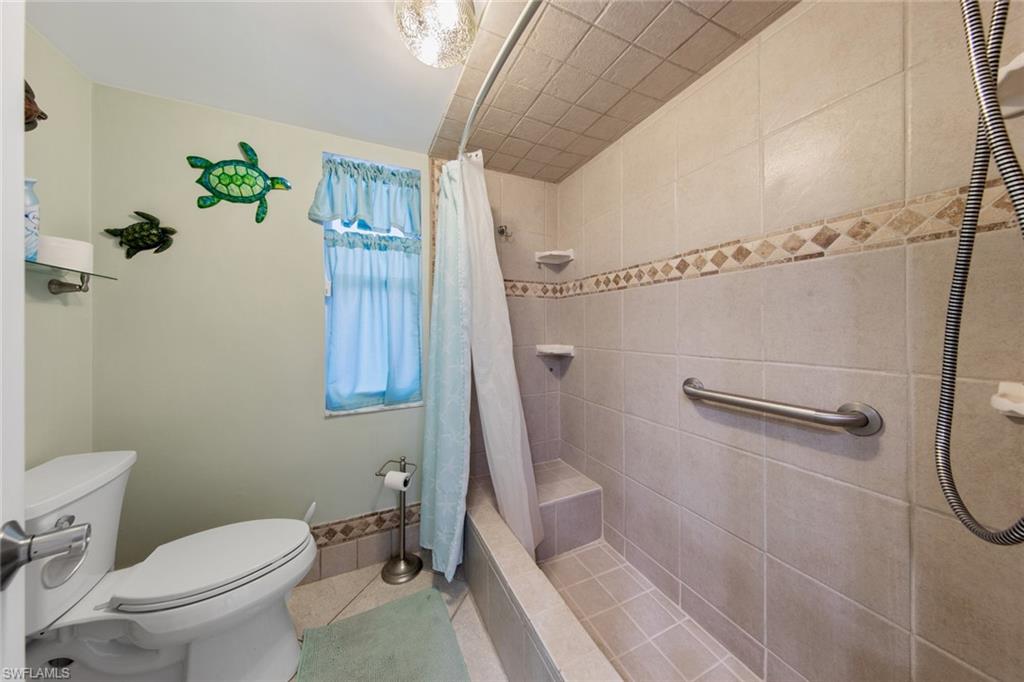 263 Candycane Lane, Unit 5 Naples, FL 34112 - Photo 27 of 49 a bathroom with a toilet and a shower