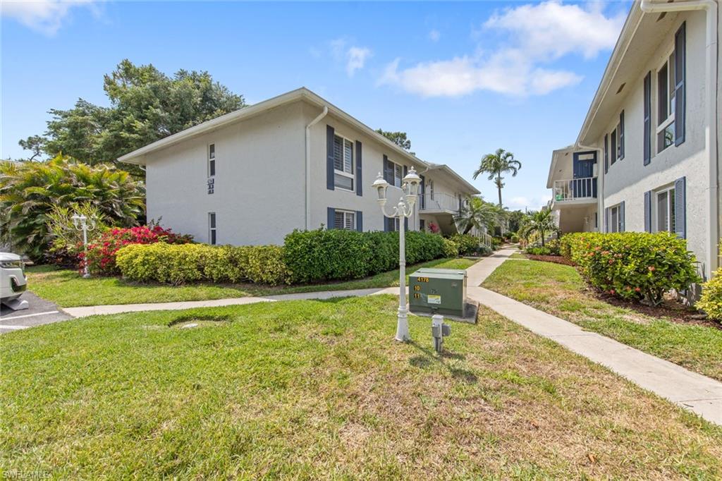 263 Candycane Lane, Unit 5 Naples, FL 34112 - Photo 3 of 49 a house view with swimming pool in front of it