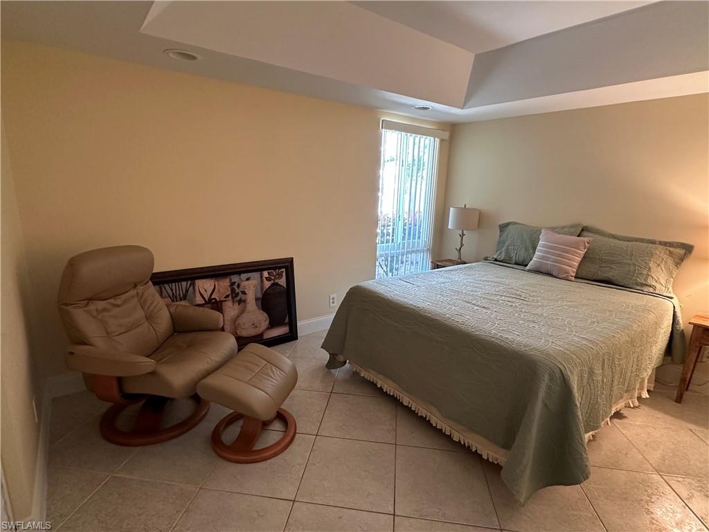 263 Candycane Lane, Unit 5 Naples, FL 34112 - Photo 31 of 49 a bedroom with a bed and a couch