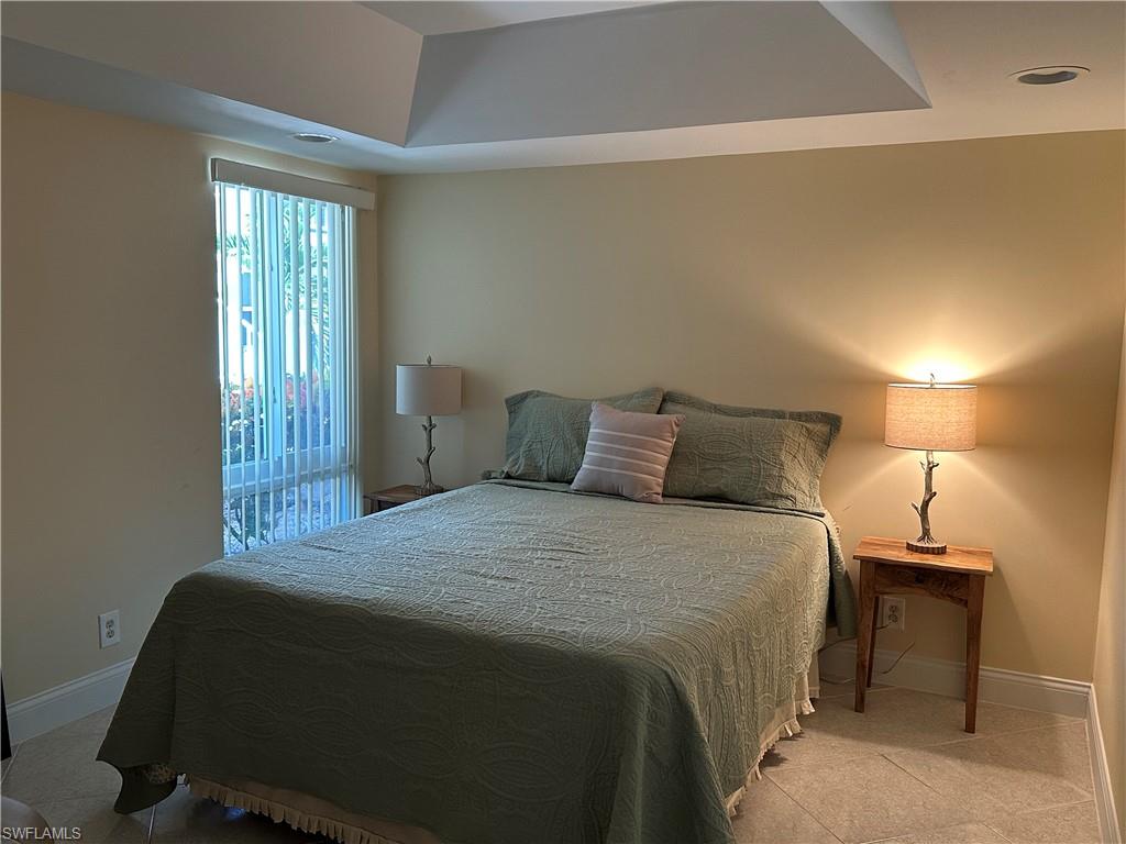 263 Candycane Lane, Unit 5 Naples, FL 34112 - Photo 32 of 49 a bedroom with a bed and a window