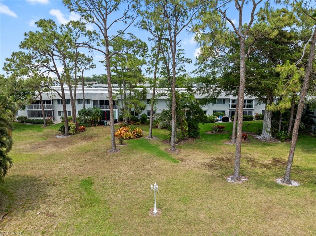 263 Candycane Lane, Unit 5 Naples, FL 34112 - Photo 35 of 49 a swimming pool with outdoor seating and yard