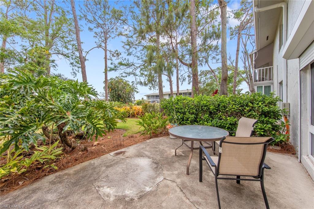 263 Candycane Lane, Unit 5 Naples, FL 34112 - Photo 5 of 49 a view of a table and chairs in back yard of the house