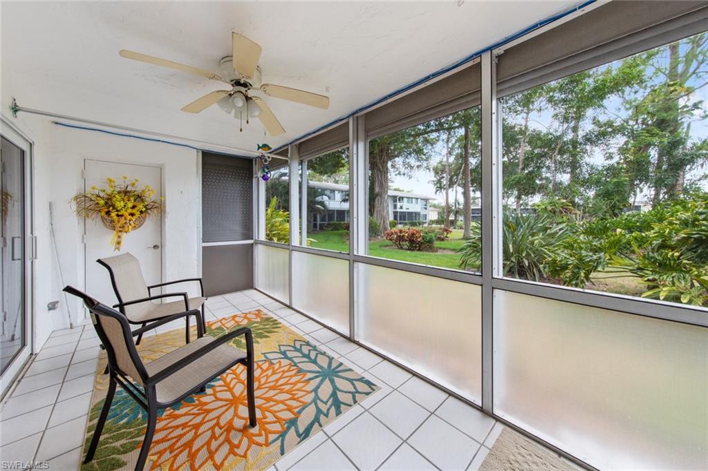 263 Candycane Lane, Unit 5 Naples, FL 34112 - Photo 7 of 49 a view of a hallway with wooden floor and dining table