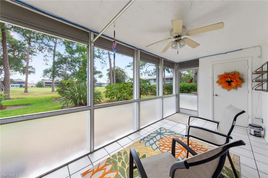 263 Candycane Lane, Unit 5 Naples, FL 34112 - Photo 9 of 49 a view of a living room and balcony with furniture