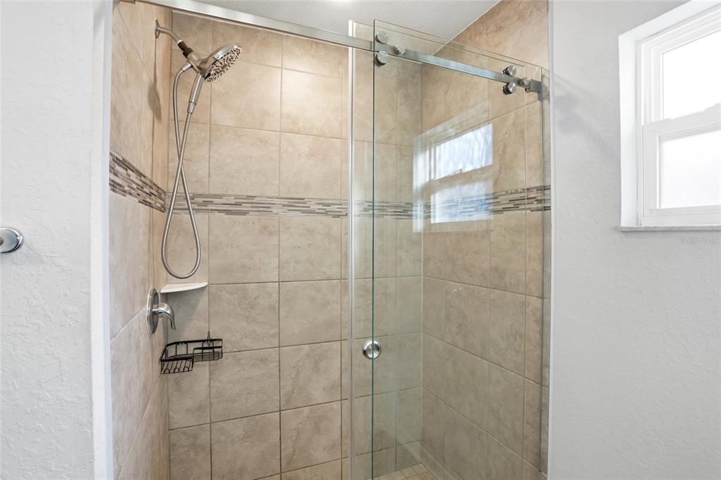 128 Foxtail Loop Davenport, FL 33837 - Photo 16 of 37 a bathroom with a shower