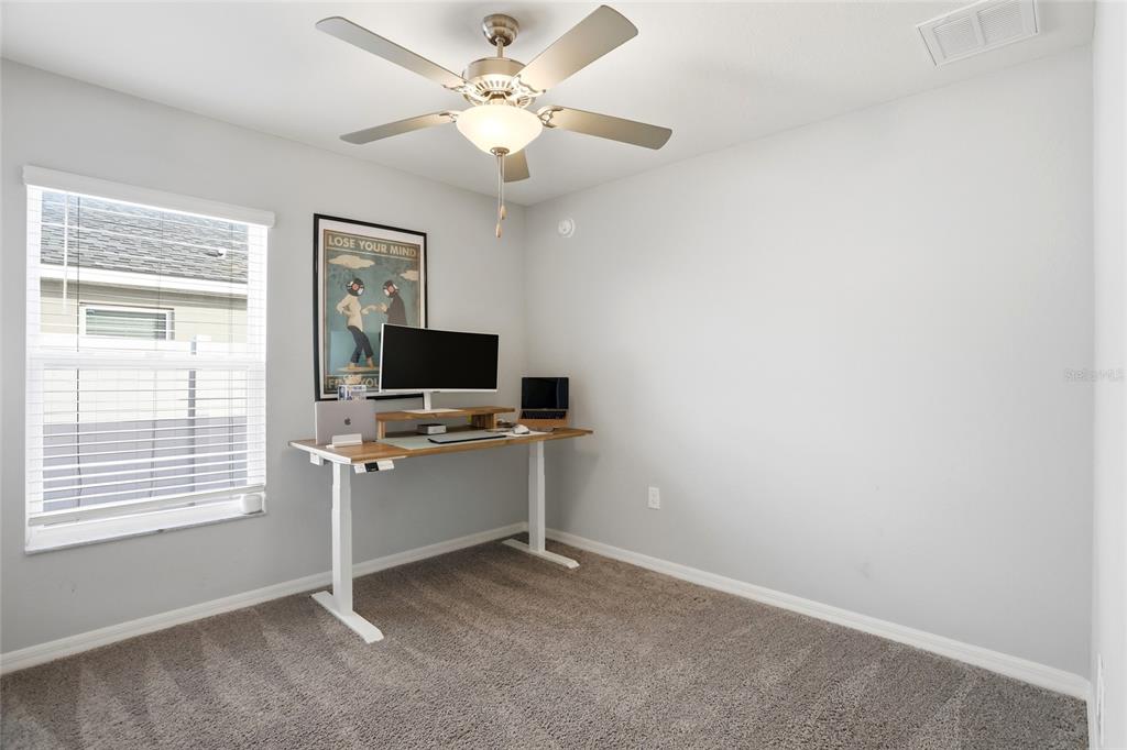 128 Foxtail Loop Davenport, FL 33837 - Photo 23 of 37 a view of a livingroom with a flat screen tv