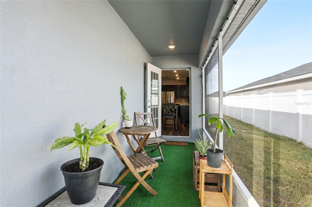 128 Foxtail Loop Davenport, FL 33837 - Photo 28 of 37 a vase of flowers sitting on a table with chairs