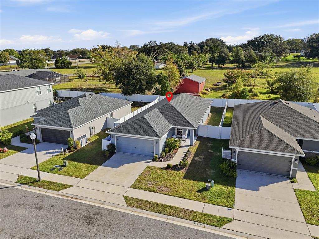 128 Foxtail Loop Davenport, FL 33837 - Photo 33 of 37 an aerial view of a house with a garden and lake view