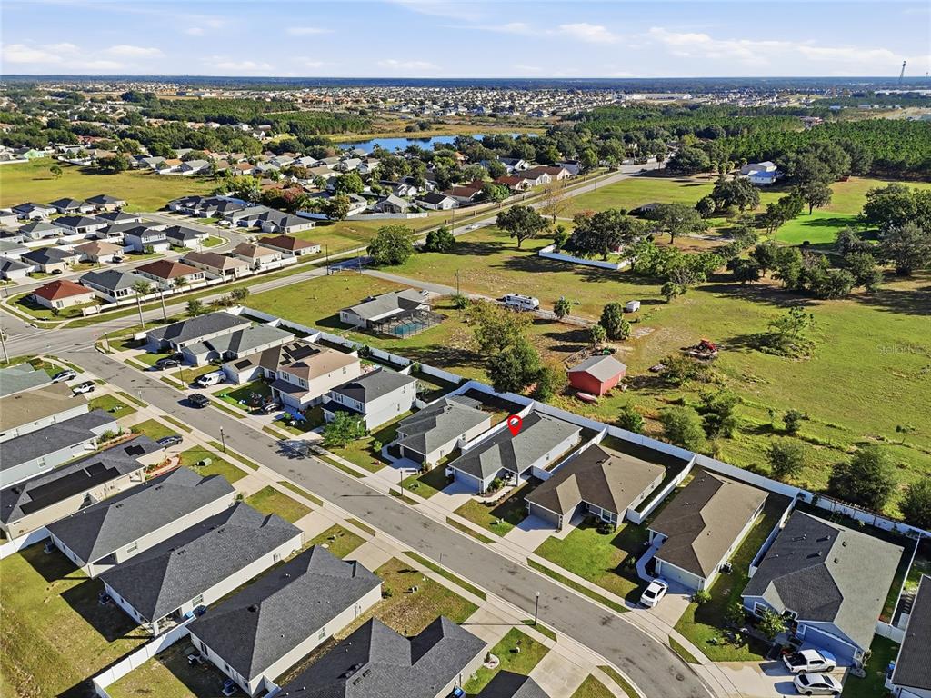 128 Foxtail Loop Davenport, FL 33837 - Photo 36 of 37 an aerial view of residential building and lake view
