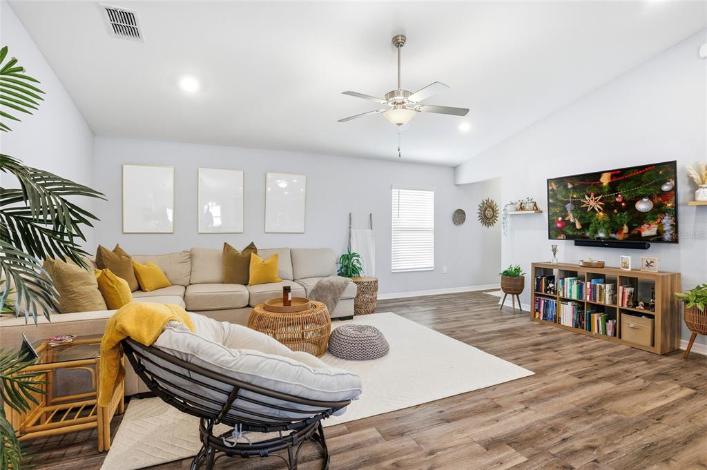 128 Foxtail Loop Davenport, FL 33837 - Photo 10 of 37 a living room with furniture and a flat screen tv