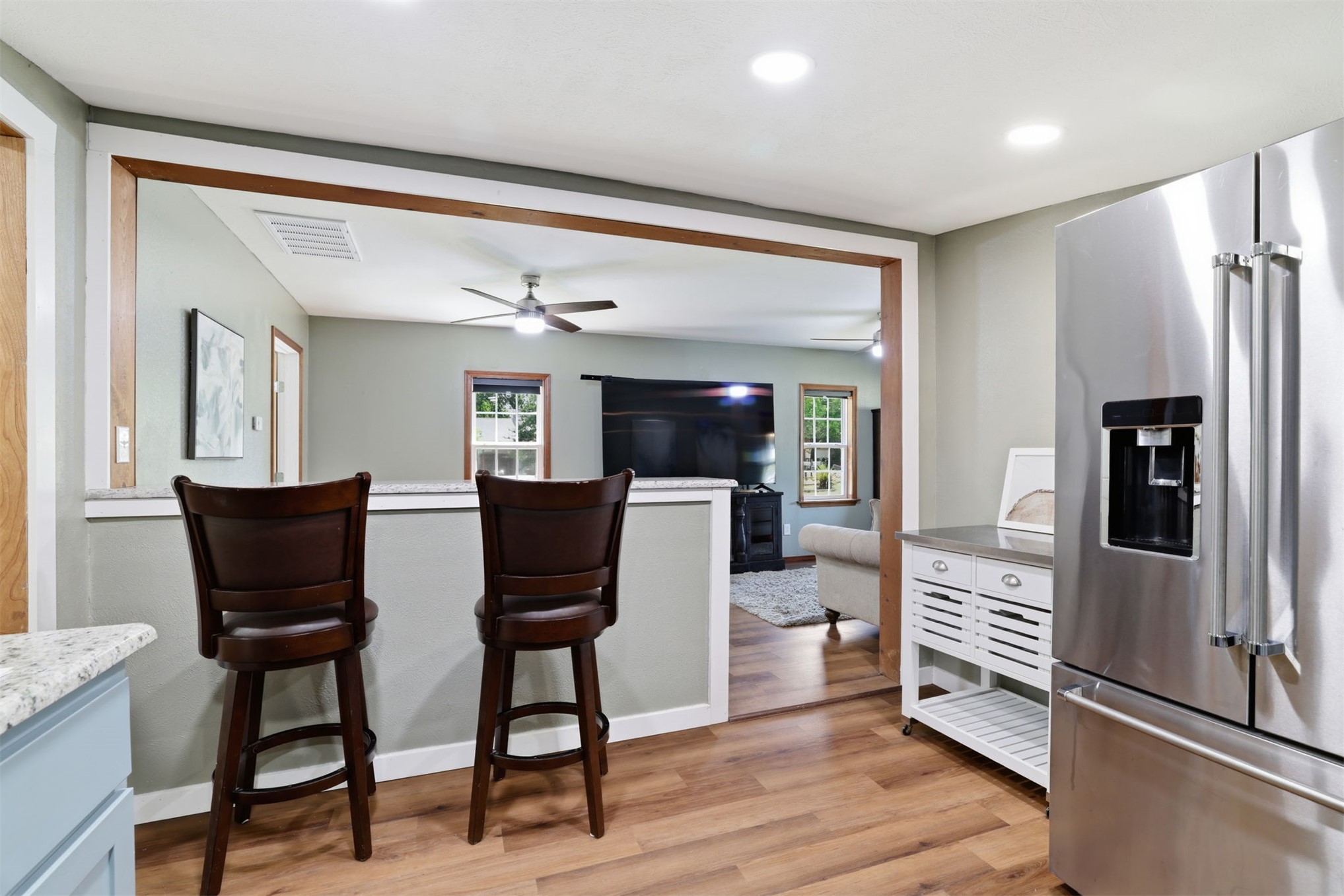 210 Main Caddo, OK 74729 - Photo 13 of 30 Kitchen featuring wood-finish flooring, recessed lighting, and a stainless steel refrigerator with an external ice/water dispenser