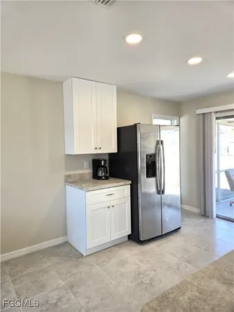 a view of a kitchen with refrigerator and stove
