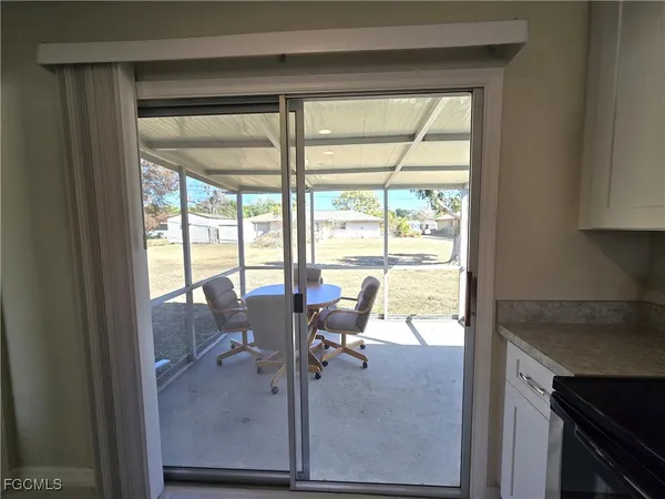 a dining room with furniture and a floor to ceiling window