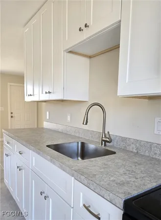 a close view of a sink a faucet and dishwasher in a kitchen