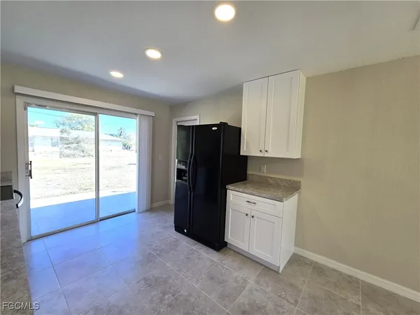 a kitchen with a refrigerator and window