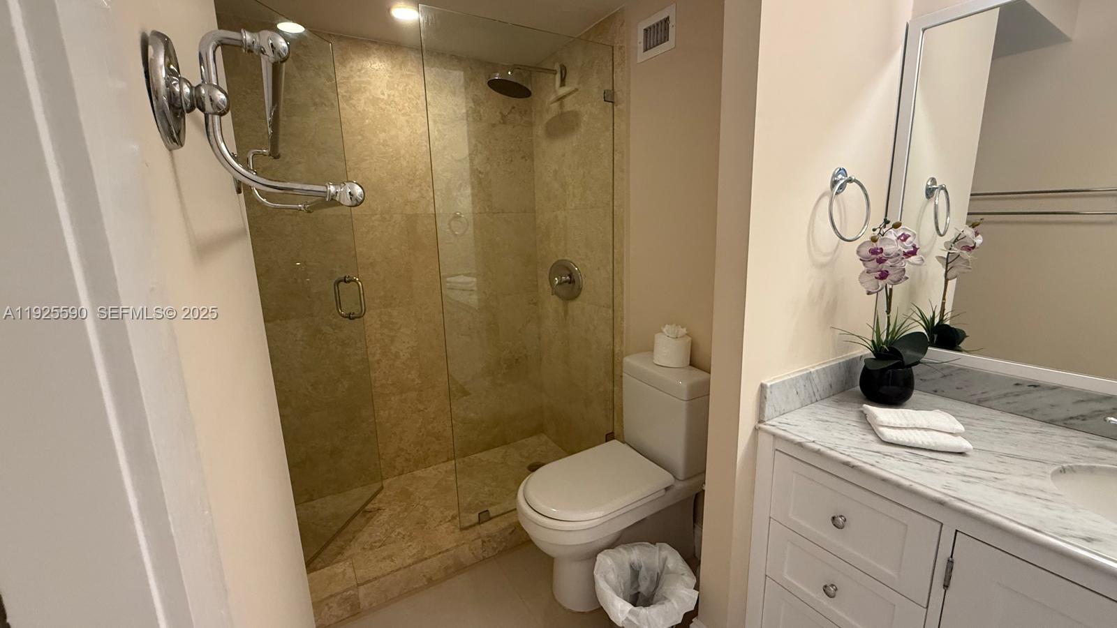 100 Lincoln Road, Unit 1108 Miami Beach, FL 33139 - Photo 11 of 26 a bathroom with a granite countertop sink toilet and shower