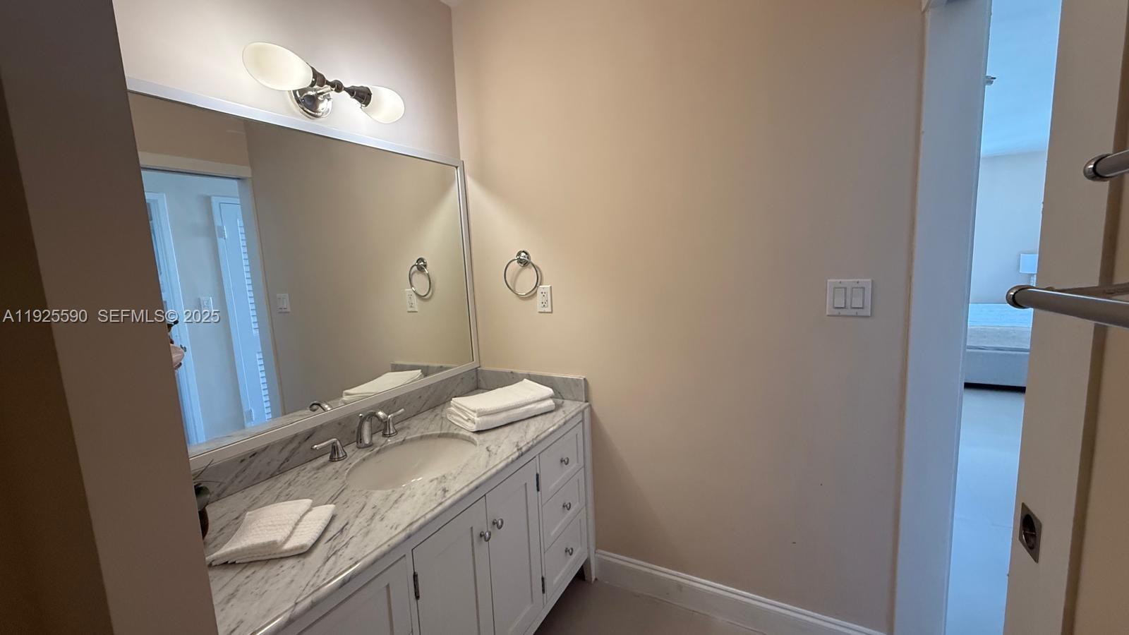 100 Lincoln Road, Unit 1108 Miami Beach, FL 33139 - Photo 12 of 26 a bathroom with a granite countertop sink and a mirror