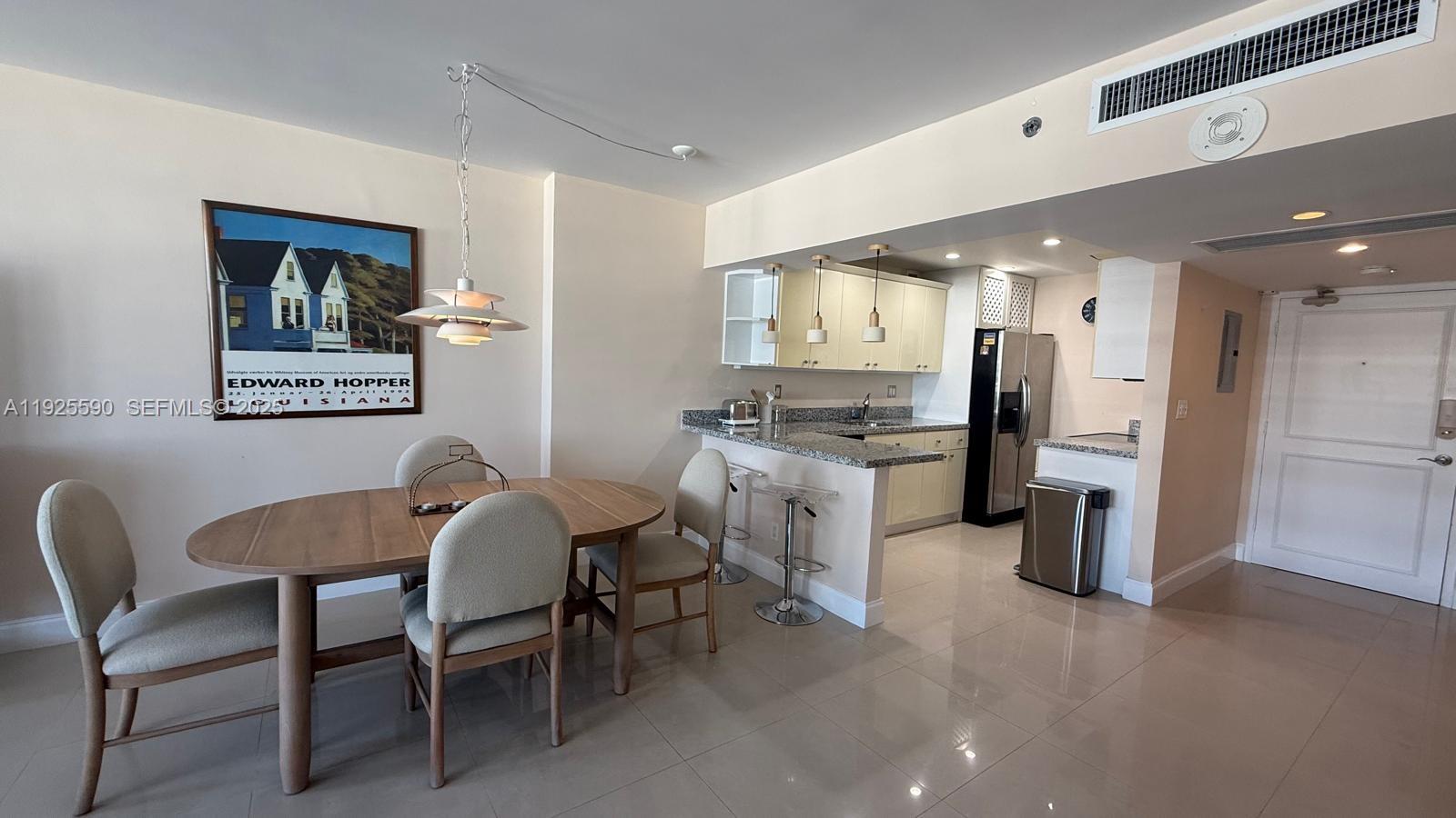 100 Lincoln Road, Unit 1108 Miami Beach, FL 33139 - Photo 2 of 26 a view of a dining room with furniture and a kitchen