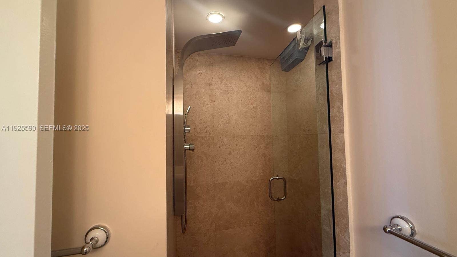 100 Lincoln Road, Unit 1108 Miami Beach, FL 33139 - Photo 6 of 26 a bathroom with a glass shower door