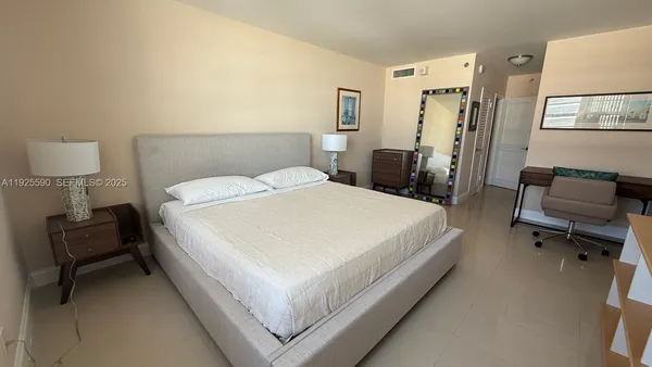 a bed room with a bed and a chair