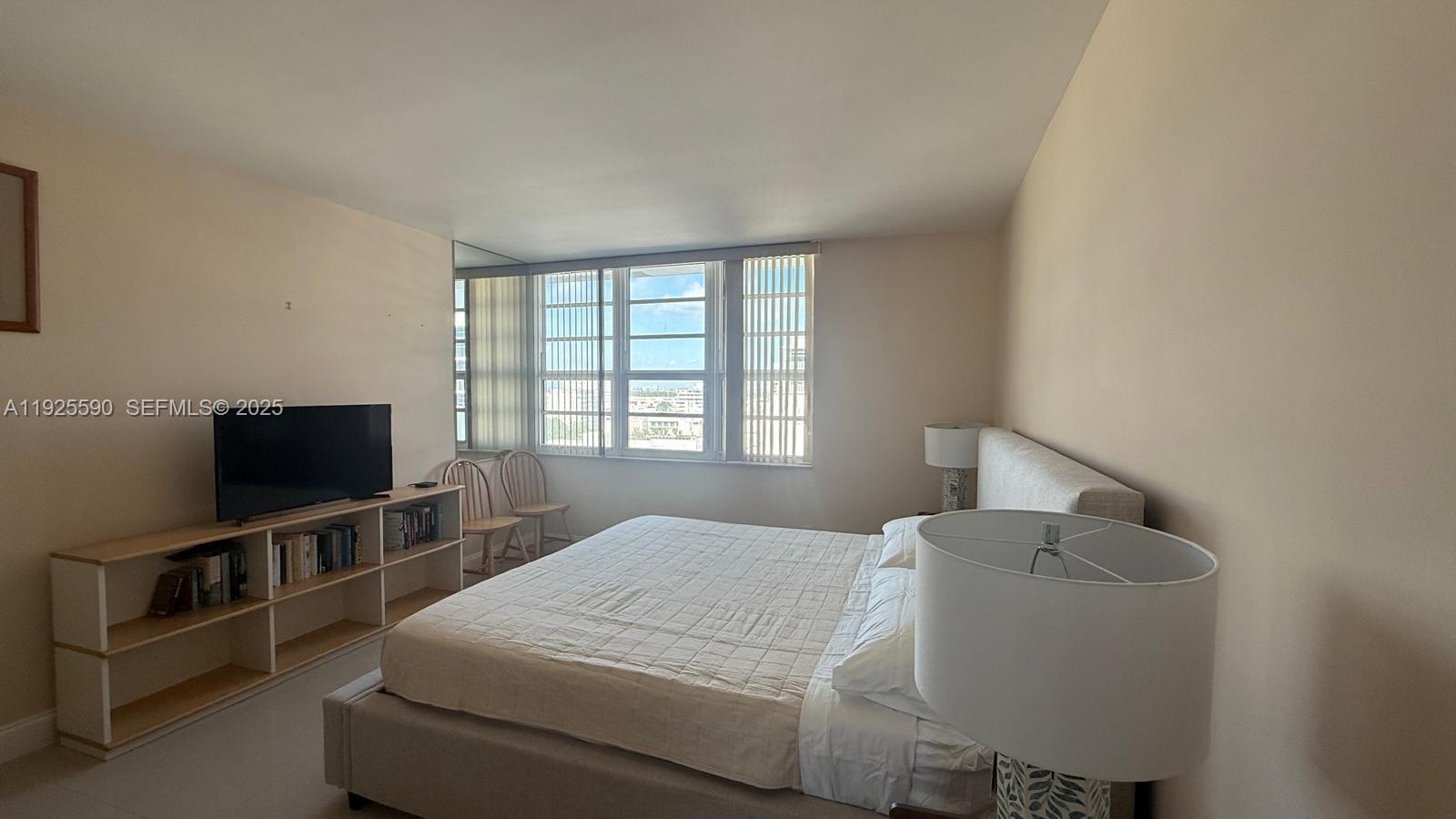 100 Lincoln Road, Unit 1108 Miami Beach, FL 33139 - Photo 9 of 26 a bedroom with a bed and a flat screen tv