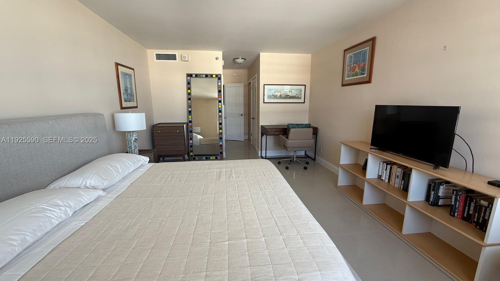 100 Lincoln Road, Unit 1108 Miami Beach, FL 33139 - Photo 10 of 26 a bedroom with a bed and a flat screen tv