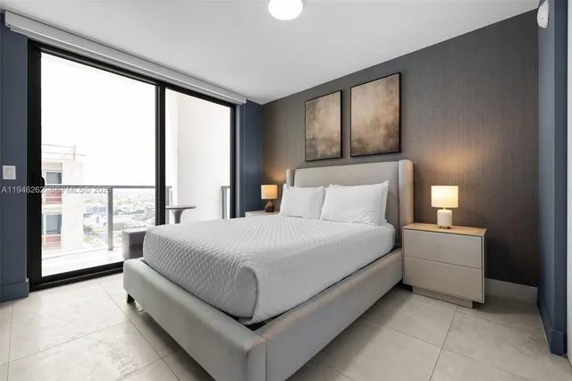 a bedroom with a bed and glass door