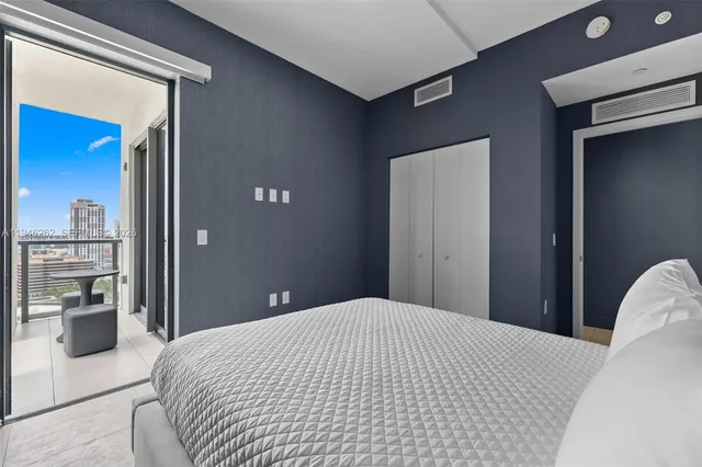 a living room with furniture a flat screen tv and a potted plant