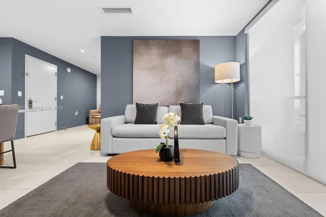 a kitchen with stainless steel appliances kitchen island granite countertop a refrigerator a stove a sink dishwasher with a dining table and chairs