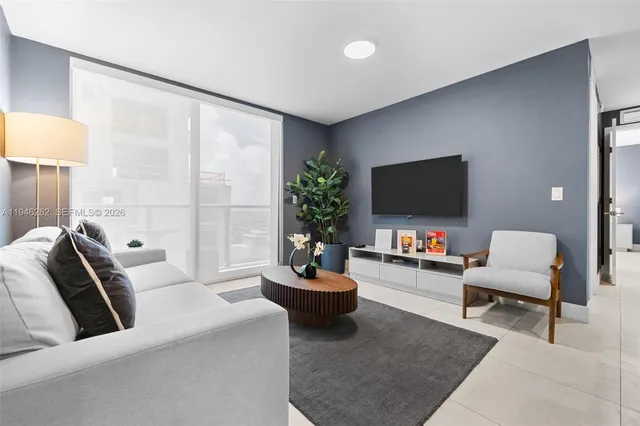 a living room with furniture a rug and a table