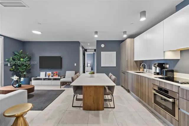 a kitchen with stainless steel appliances granite countertop a sink a stove and a microwave