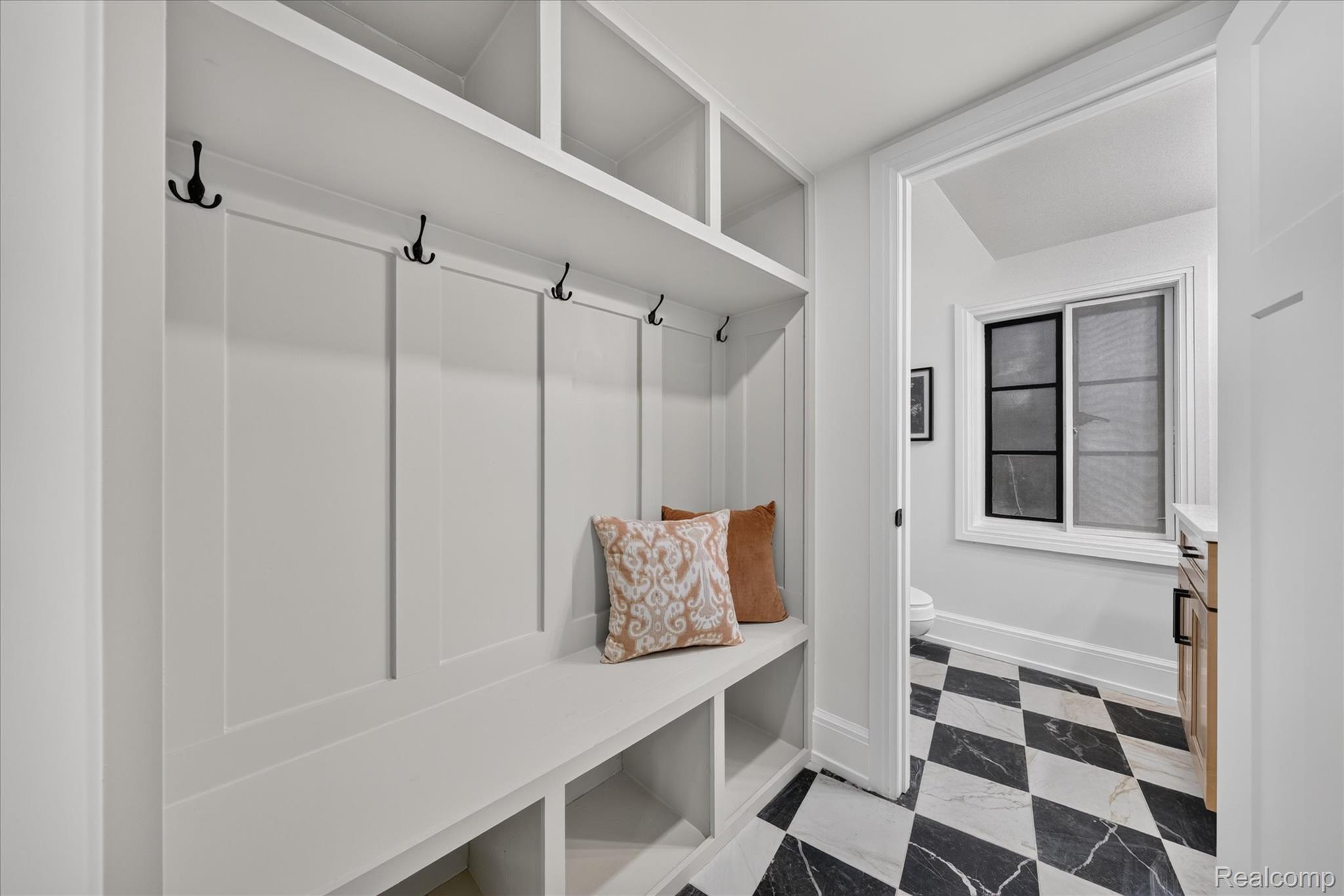 3250 Sherbourne Road Detroit, MI 48221 - Photo 9 of 36 Built-in storage bench with overhead shelving and wall-mounted hooks