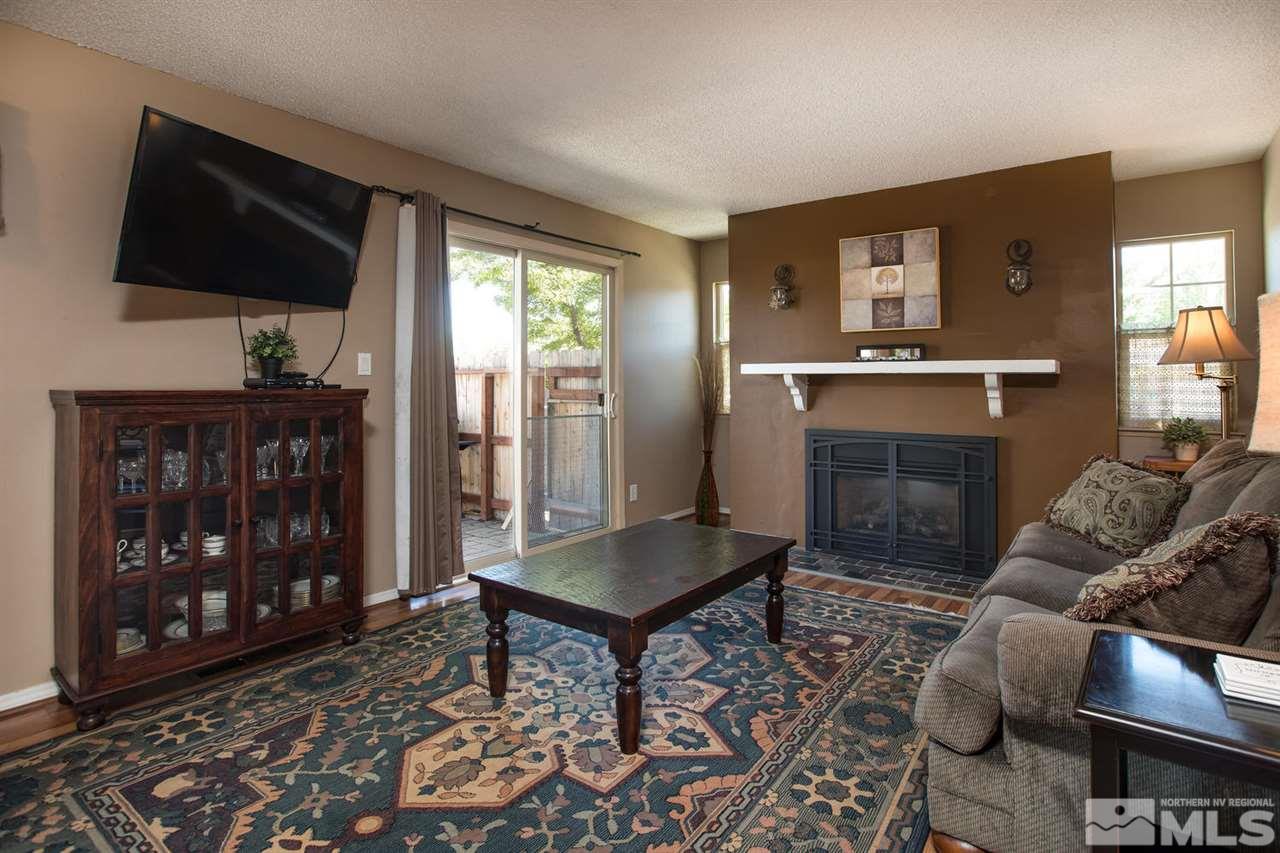 1845 Kings Row Reno, NV 89503 - Photo 4 of 25 a living room with furniture a flat screen tv and a fireplace