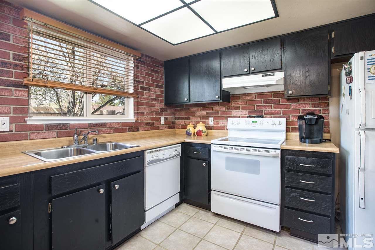 1845 Kings Row Reno, NV 89503 - Photo 8 of 25 a kitchen with a sink stove and cabinets