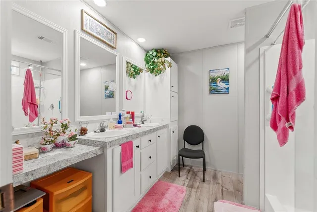 a bathroom with a granite countertop sink mirror and vanity