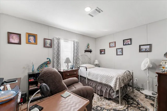 a bedroom with furniture and a window
