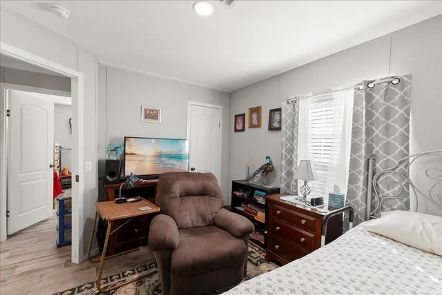 a bedroom with furniture and a window