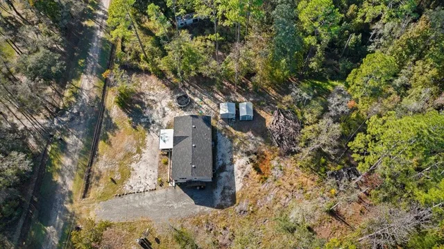a backyard of a house with large trees