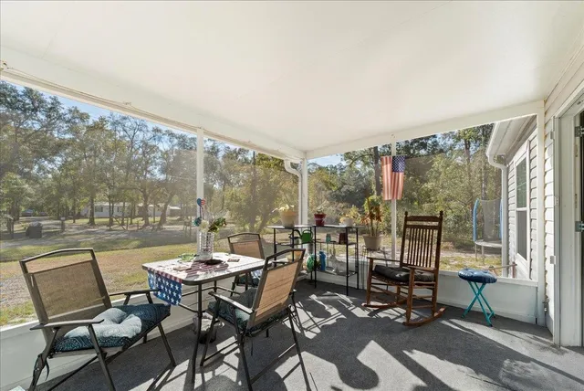 a view of a patio with a dining table and chairs