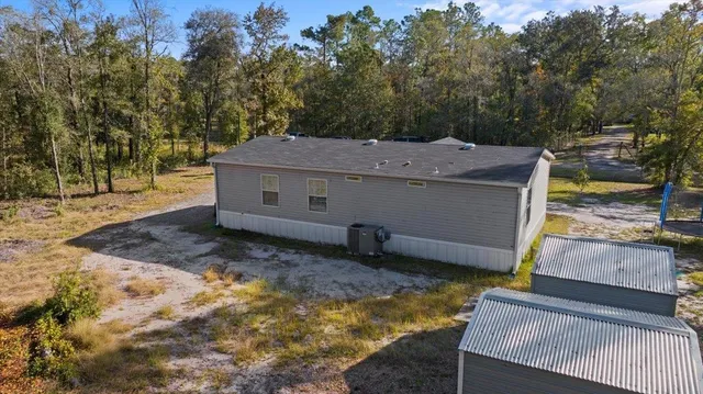 a view of a house with backyard and sitting area