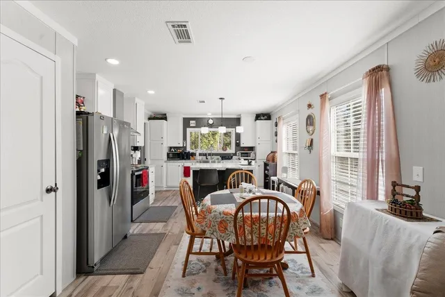 a dining room with furniture and window