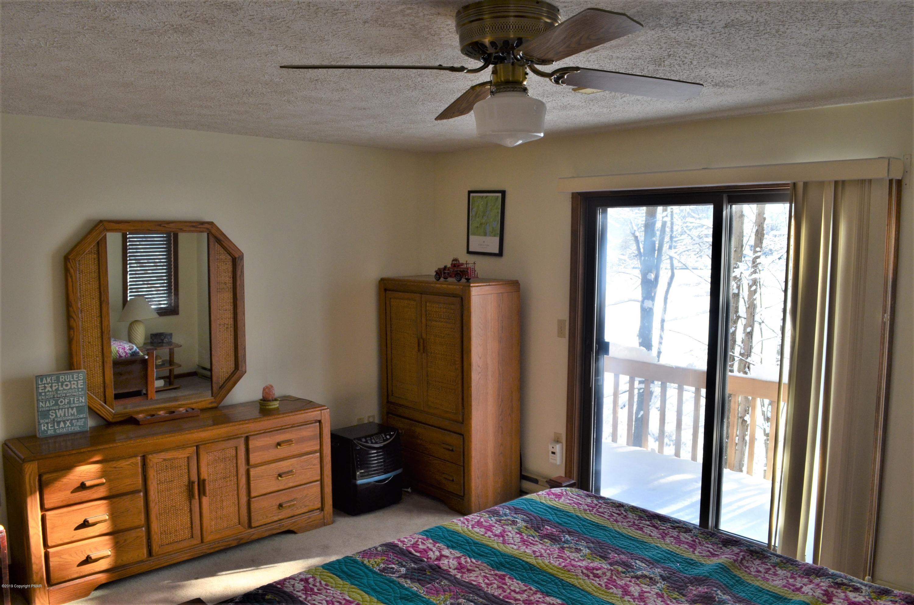 9 Birch Point Road Gouldsboro, PA 18424 - Photo 18 of 41 a bedroom with a bed a dresser and flat screen tv