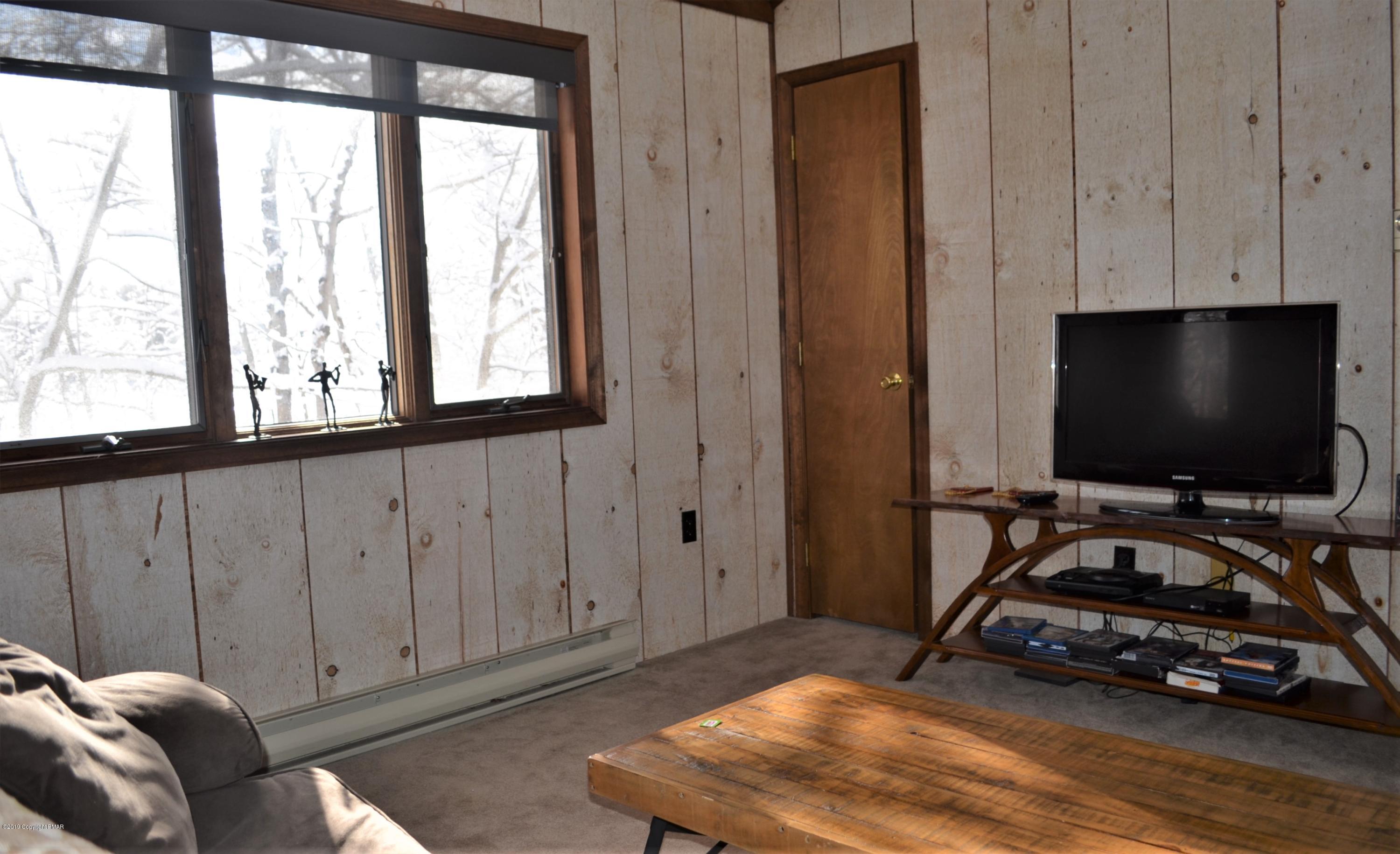 9 Birch Point Road Gouldsboro, PA 18424 - Photo 28 of 41 a bedroom with bed and a flat tv screen next to a window