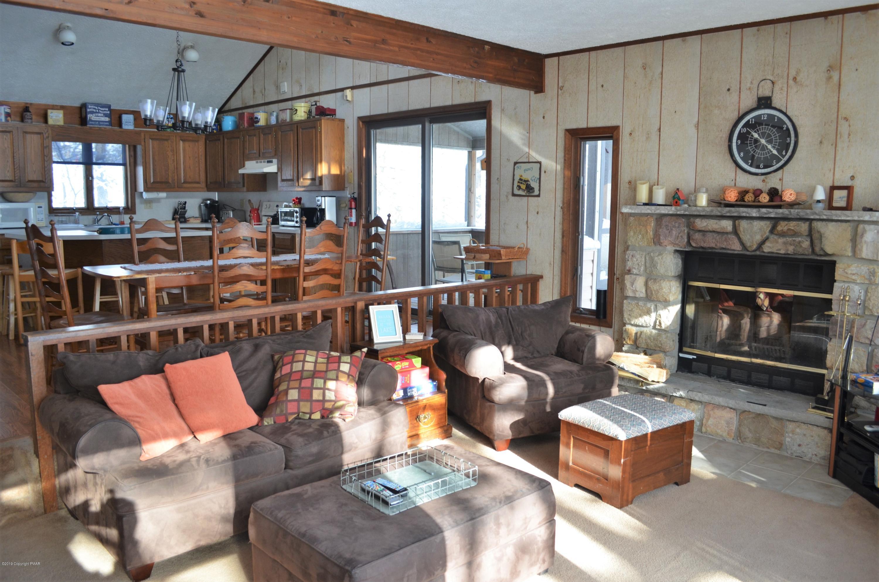 9 Birch Point Road Gouldsboro, PA 18424 - Photo 8 of 41 a living room with furniture a fireplace and a window