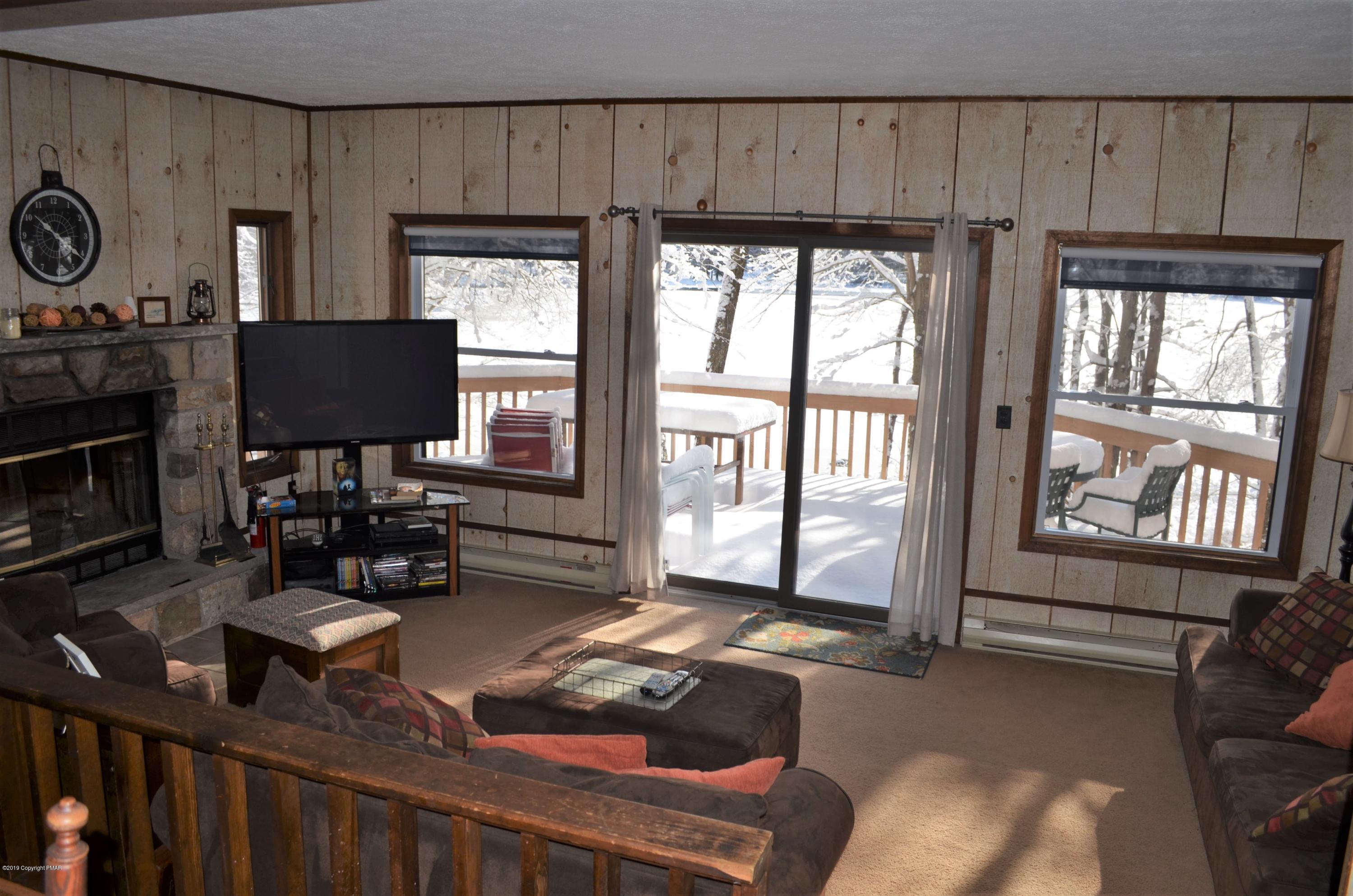 9 Birch Point Road Gouldsboro, PA 18424 - Photo 9 of 41 a living room with furniture a flat screen tv and a fireplace