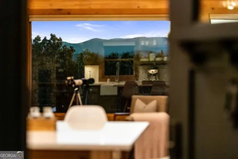 a view of a dining room with furniture and a chandelier