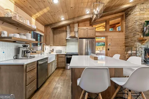 a living room with furniture a fireplace and a floor to ceiling window