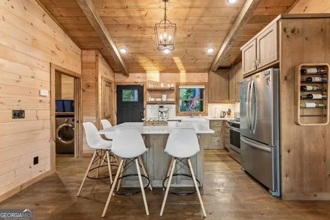 a living room with furniture a wooden floor and a chandelier