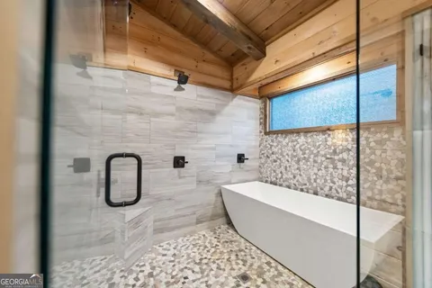 a bed sitting in a balcony next to a window